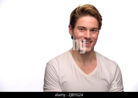 Portrait of young Caucasian man looking at camera smiling Stock Photo