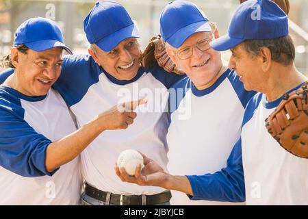 Senior men playing on baseball team Stock Photo