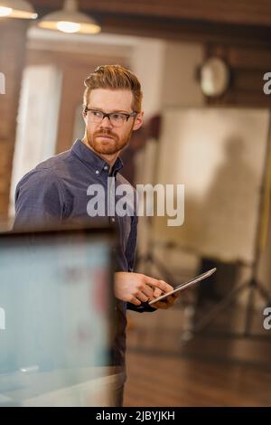 Caucasian businessman using digital tablet in office Stock Photo