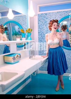 https://l450v.alamy.com/450v/2jbyjx4/vintage-styled-woman-leaning-on-counter-in-a-mid-century-bathroom-with-hair-curlers-in-her-hair-2jbyjx4.jpg