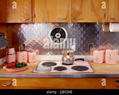 Mid century pink kitchen with pink appliances. - SuperStock