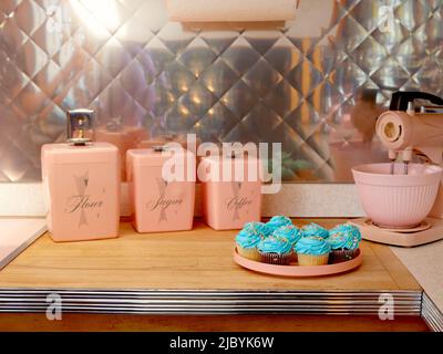 Mid century pink kitchen with pink appliances. - SuperStock