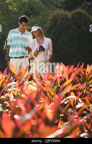 Couple golfing together Stock Photo