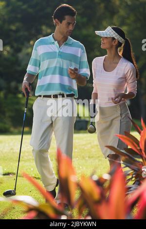 Couple golfing together Stock Photo