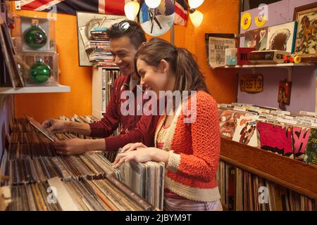 Couple looking at albums in record store Stock Photo
