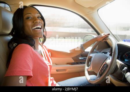 Smiling African American woman driving car Stock Photo
