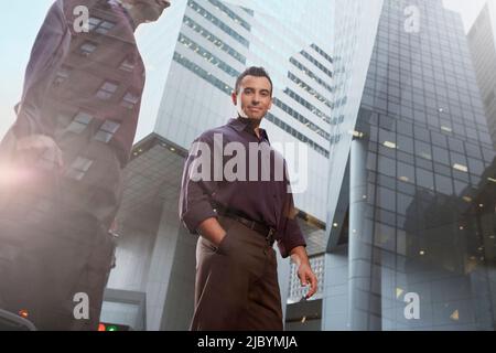 Hispanic businessman walking in urban city Stock Photo