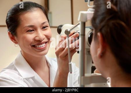 Optician examining patient's vision Stock Photo