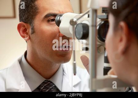 Optician examining patient's vision Stock Photo