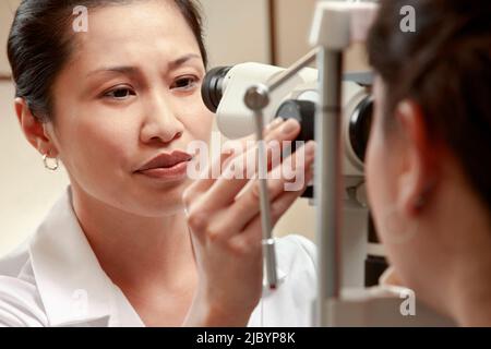 Optician examining patient's vision Stock Photo