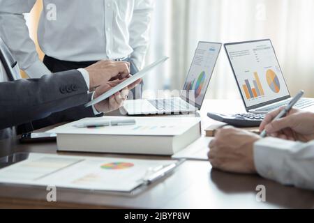 Businessmen or analysts in a meeting room reviewing and discuss on financial statements for a return on investment Stock Photo