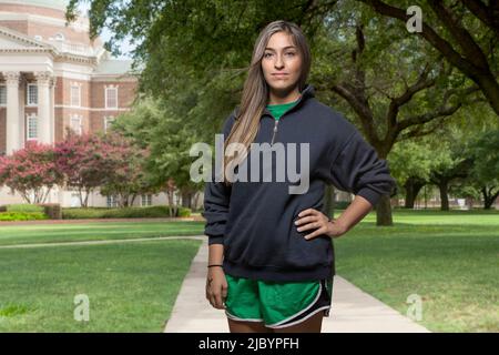 Middle Eastern student standing on college campus Stock Photo