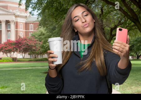 Middle Eastern student taking selfie on college campus Stock Photo