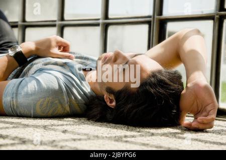 Korean man laying on floor Stock Photo