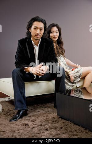 Korean couple sitting on stool Stock Photo