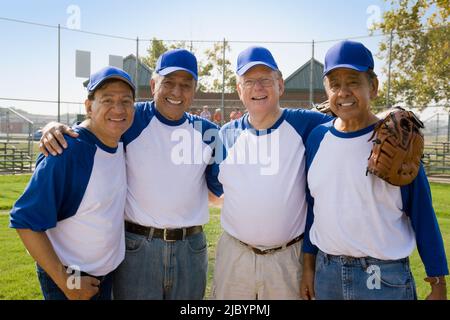 Senior men playing on baseball team Stock Photo