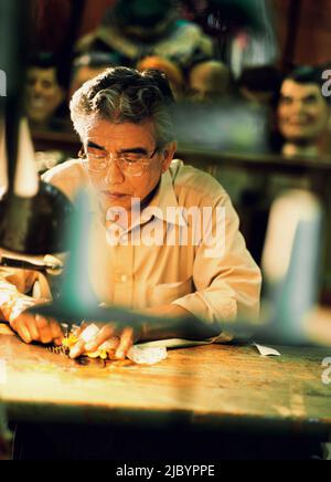 Senior man working at workshop table Stock Photo