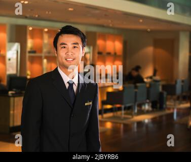 Chinese businessman standing in bar Stock Photo