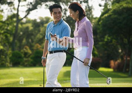 Chinese couple playing golf Stock Photo