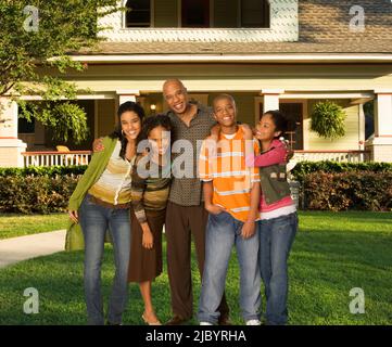 Family standing in yard together Stock Photo