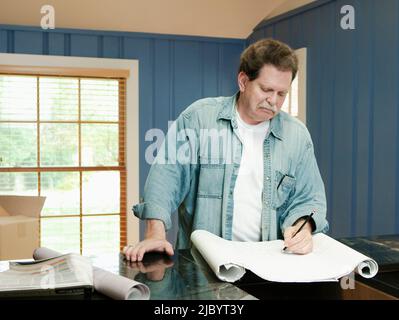 Architect reviewing blueprints Stock Photo