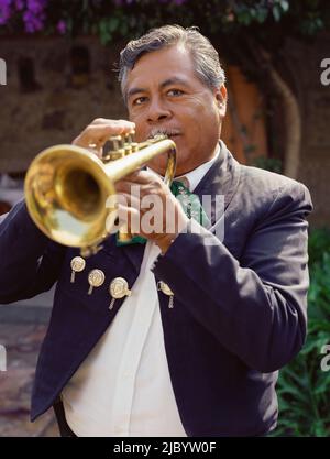 Hispanic man playing trumpet Stock Photo