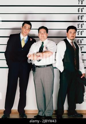 Hispanic men standing in police line-up Stock Photo