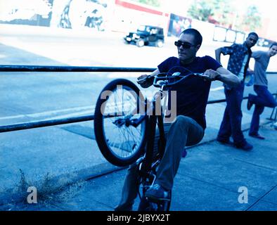 Young man doing stunt on bicycle Stock Photo