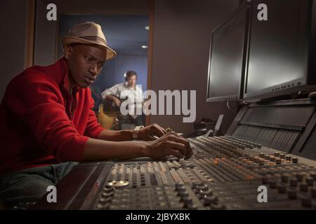 African American man working at audio control panel Stock Photo