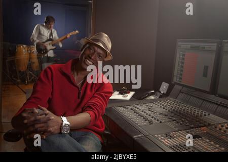 African American man working at audio control panel Stock Photo