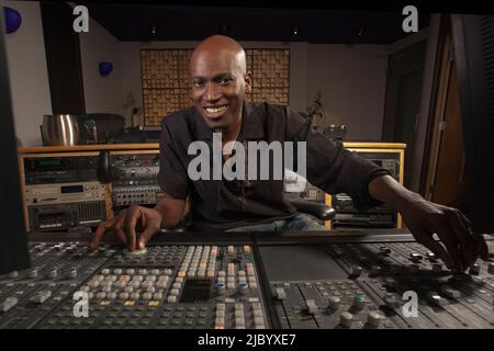 African American man working at audio control panel Stock Photo
