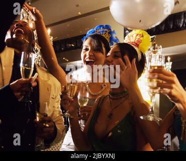 Multi-ethnic friends at New Year's Eve party Stock Photo
