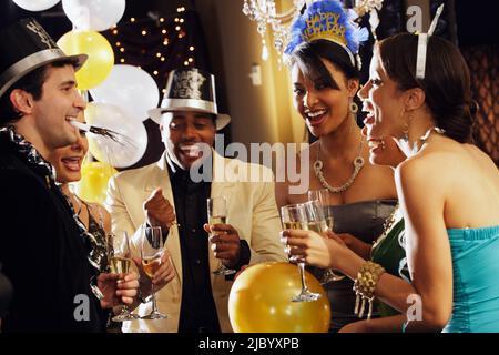 Multi-ethnic friends at New Year's Eve party Stock Photo
