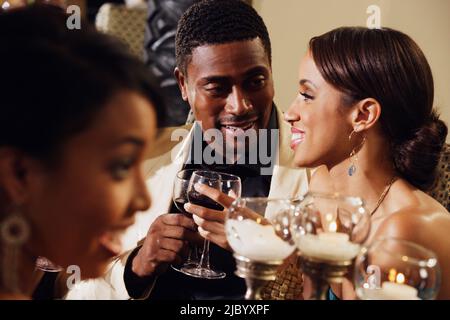 Multi-ethnic couple drinking wine at dinner party Stock Photo