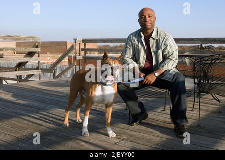 African man and dog on deck - dogs Stock Photo