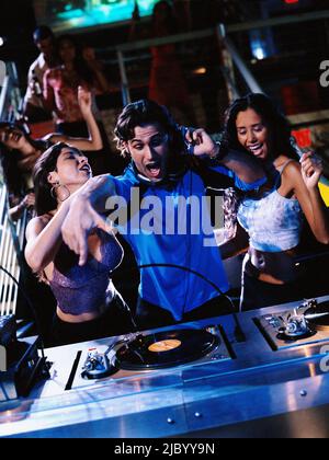 Male DJ dancing with two women Stock Photo