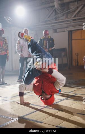 Multi-ethnic break-dancers in warehouse Stock Photo