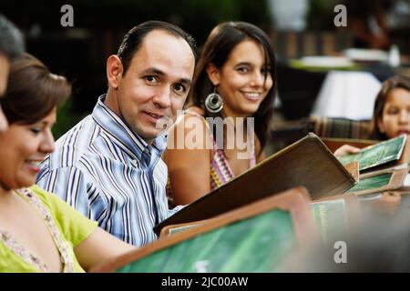 Middle-aged man smiling for the camera at a restaurant Stock Photo