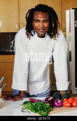 Portrait of male chef standing in kitchen Stock Photo