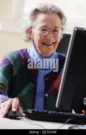 Elderly woman using a computer Stock Photo