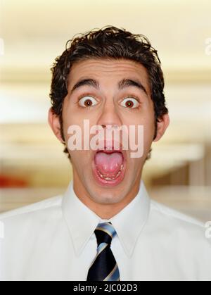 Portrait of businessman screaming with mouth wide open Stock Photo