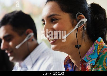 Young woman talking on a headset Stock Photo