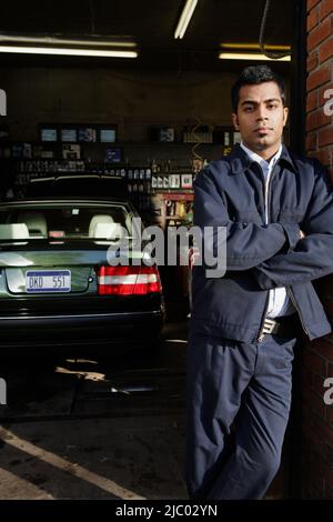 Young man posing for the camera in garage Stock Photo