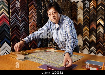 Middle aged man framing a picture Stock Photo