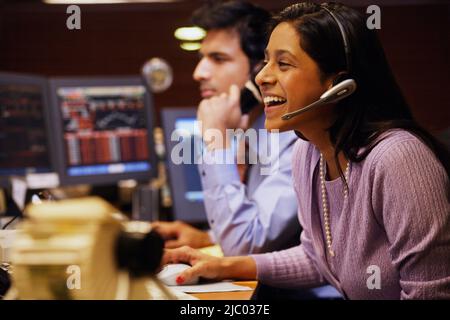 Businesswoman laughing while talking on a headset Stock Photo