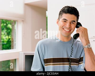 Young man talking on the phone Stock Photo
