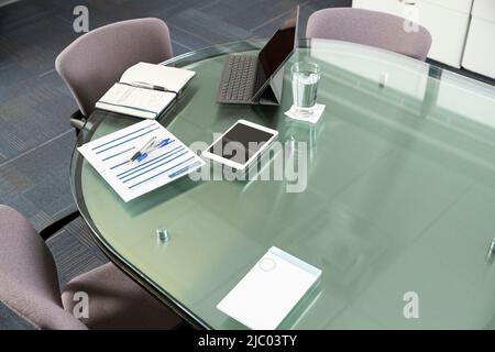 Empty overhead shot of devices on a conference table. Stock Photo
