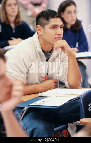 Young man listening in class Stock Photo