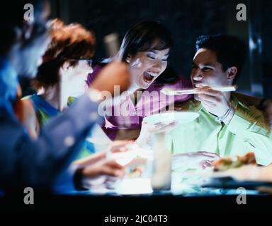 Young man feeding girlfriend rice Stock Photo