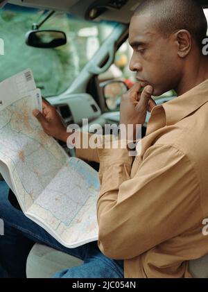Man reading map in car Stock Photo